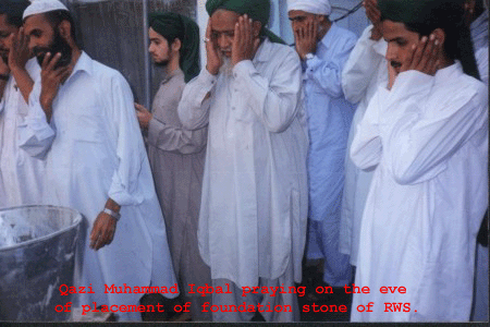 Qazi Muhammad Iqbal S/o. Qazi  Muhammad Ramzan praying on the  eve of  laying foundation stone of Ramzan Awami Hall. He is one of  them who takes keen interest in  the architecture and  design of Ramzan Awami  Hall. These are the efforts of Qazi Muhammad  Iqbal  and Qazi Muhammad Afzal to install the wiring in the Said Hall.